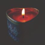 photo of heart shaped candle with flame