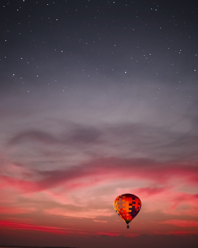 photo of hot air balloon in sunset with stars