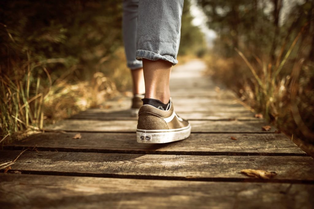 photo of one pair of feet walking along a path